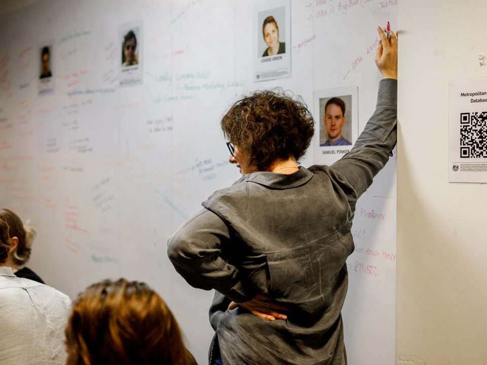 A juror puts the pieces together on an evidence wall.